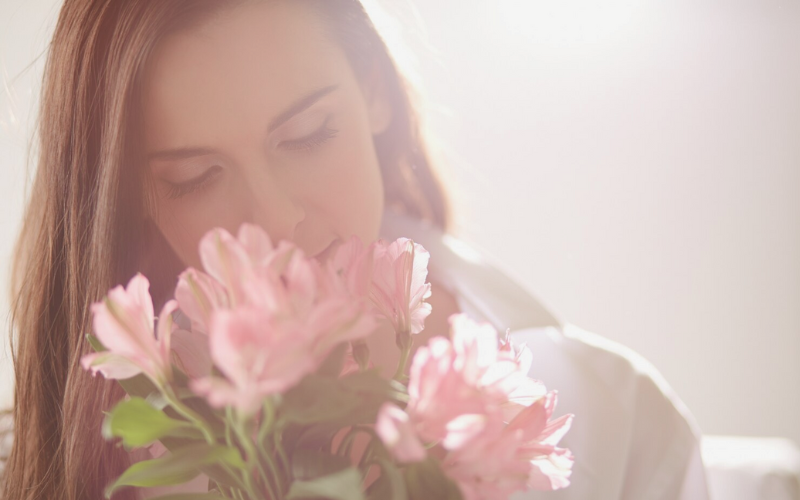 woman smelling flowers