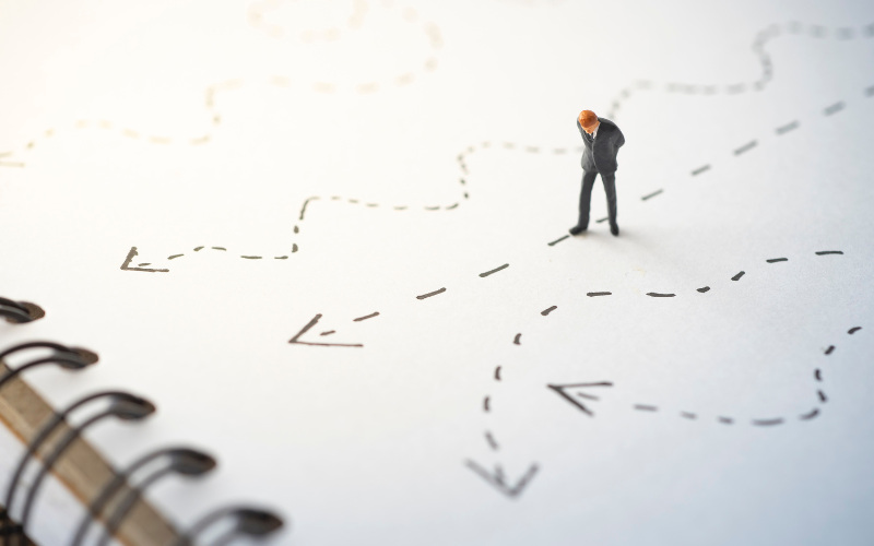 Businessman looking at different directions